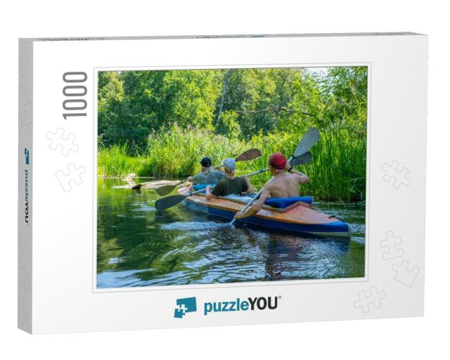 A Group of Three People Paddle in a Kayak. Rafting on the... Jigsaw Puzzle with 1000 pieces