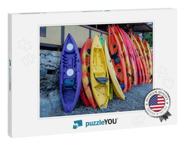 Many Multi-Colored Boats, Kayaks & Canoes, Are Moored At... Jigsaw Puzzle