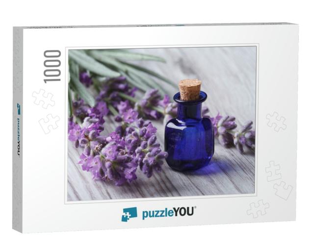 Lavender Oil in a Glass Bottle on a Background of Fresh F... Jigsaw Puzzle with 1000 pieces