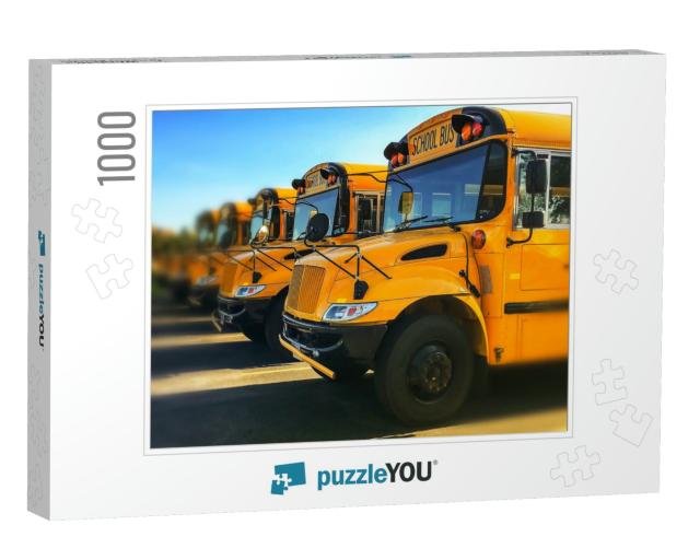 Row of Yellow School Buses Parked Inline with Blurred Bac... Jigsaw Puzzle with 1000 pieces