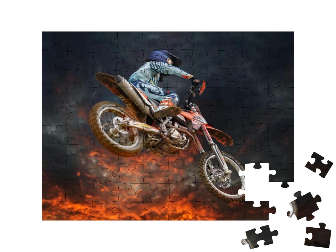Jumping Motocross Rider with Firestorm in the Background... Jigsaw Puzzle with 100 pieces