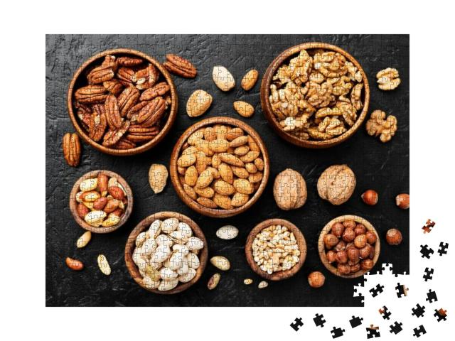 Mix of Nuts in Wooden Bowls on Black Stone Background. Wa... Jigsaw Puzzle with 1000 pieces