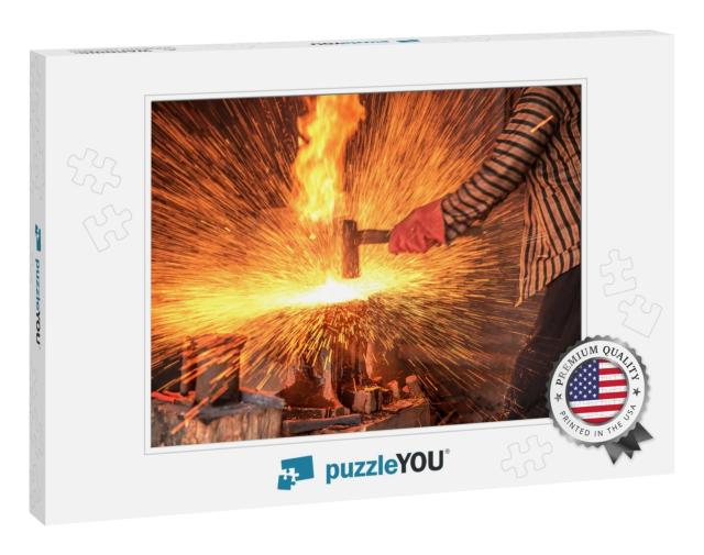 Blacksmith Forging the Molten Metal with a Hammer to Make... Jigsaw Puzzle