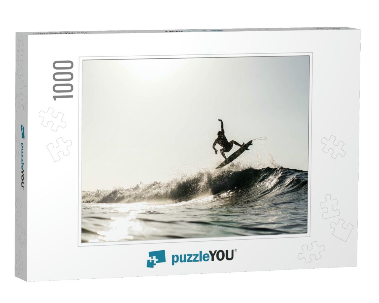 A Silhouetted Surfing Airing on a Wave Breaking on a Beac... Jigsaw Puzzle with 1000 pieces