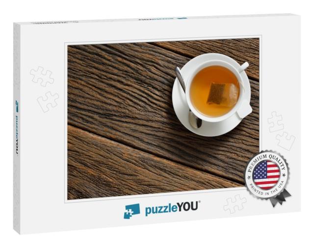 Top View of a Cup of Tea with Tea Bag on Wooden Table... Jigsaw Puzzle
