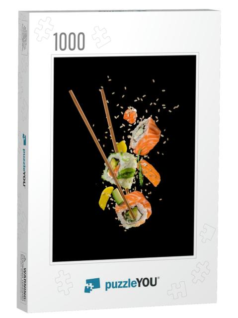 Sushi Pieces Placed Between Chopsticks, Separated on Blac... Jigsaw Puzzle with 1000 pieces