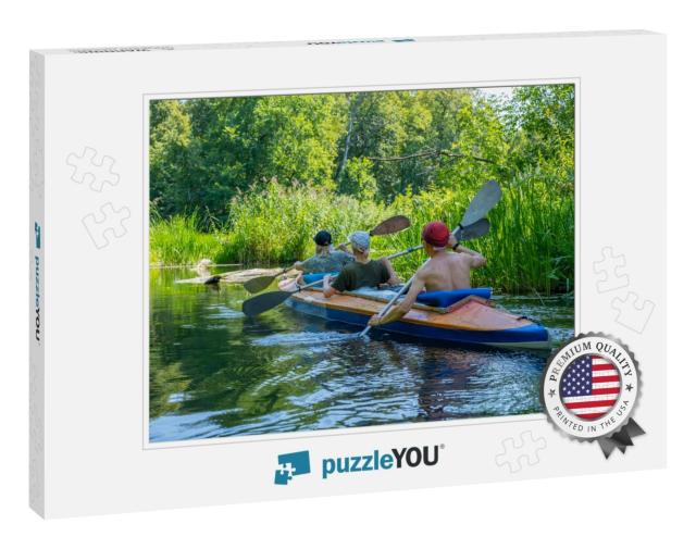 A Group of Three People Paddle in a Kayak. Rafting on the... Jigsaw Puzzle
