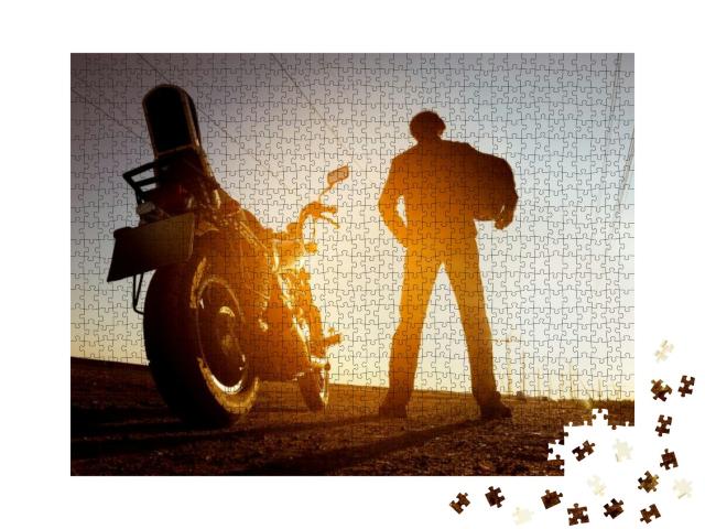 Biker with Motorbike Stands on Sunset Backdrop... Jigsaw Puzzle with 1000 pieces