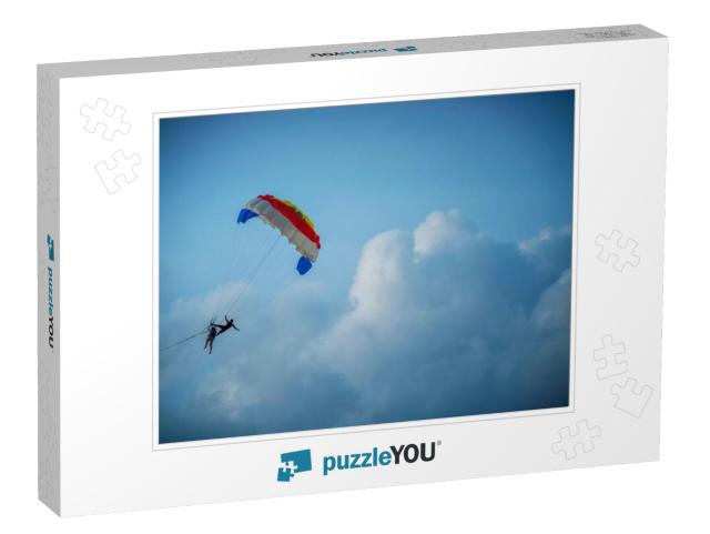 Two Tourists Are Playing the Parasailing in the Sky Durin... Jigsaw Puzzle