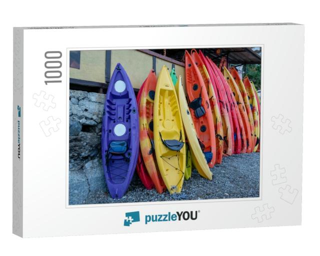 Many Multi-Colored Boats, Kayaks & Canoes, Are Moored At... Jigsaw Puzzle with 1000 pieces
