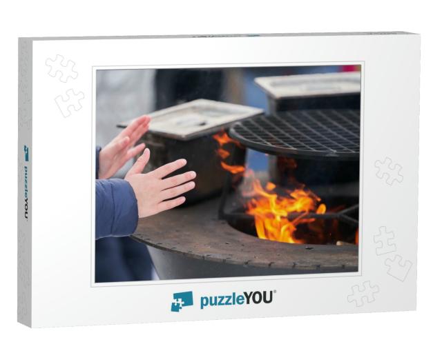 A Child Warms His Hands Over the Fire of a Street Grill... Jigsaw Puzzle